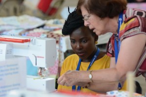 Cathy Irwin, a volunteer supervisor at the quilting station, talked about how it was letting inexperienced people come to work on quilts that will be auctioned “It makes us a bit nervous, but we want everyone to learn quilting.”
